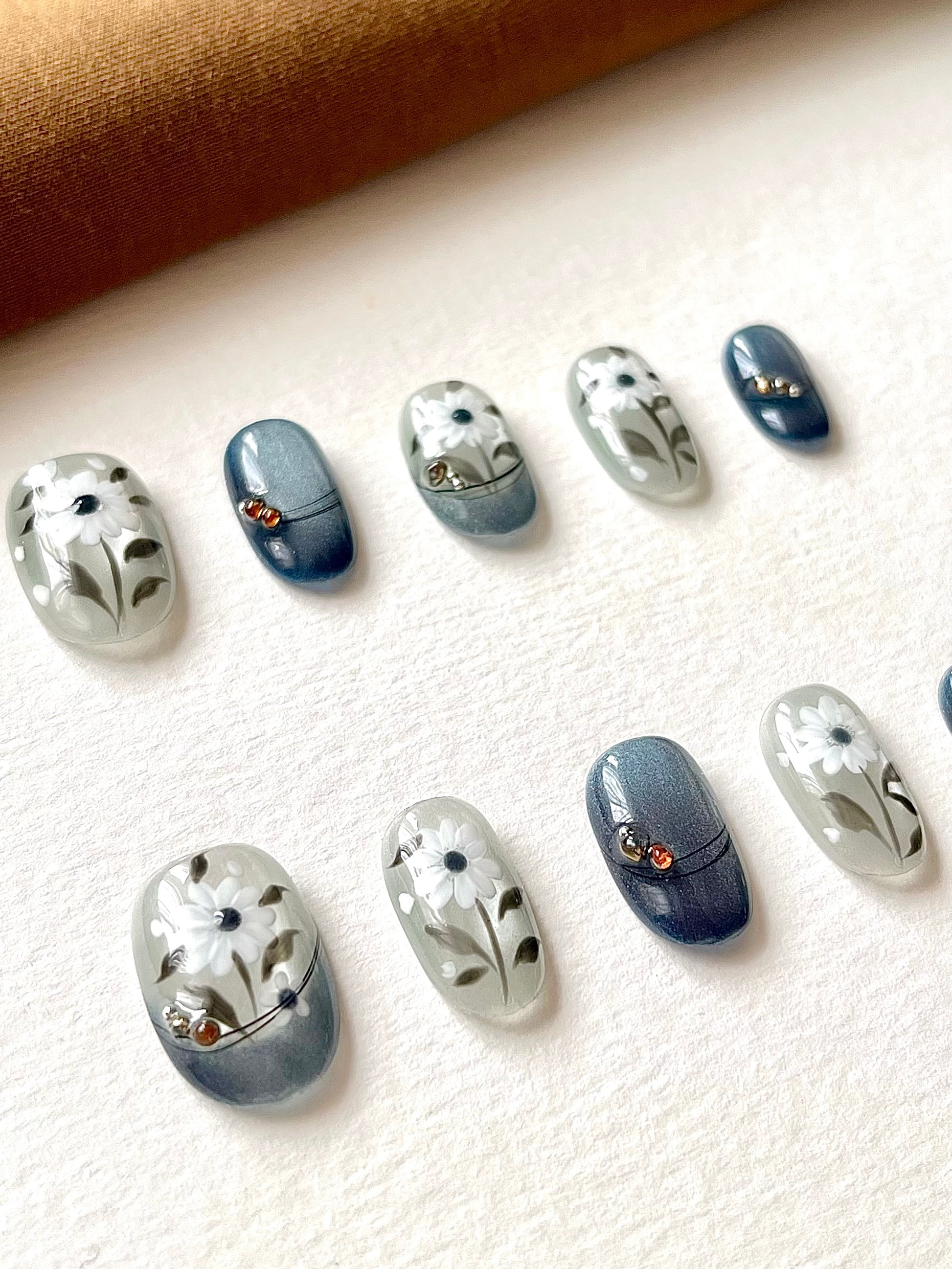 Blaue handbemalte mittellange ovale Nägel